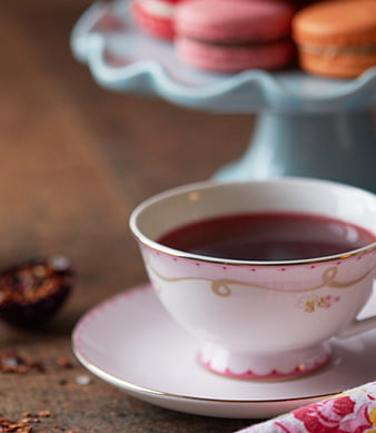 Pink Tea Cup with Macarons on Cake Stand