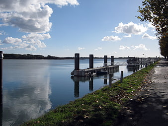 Serene River Dock with Calm Water and Blue Sky
