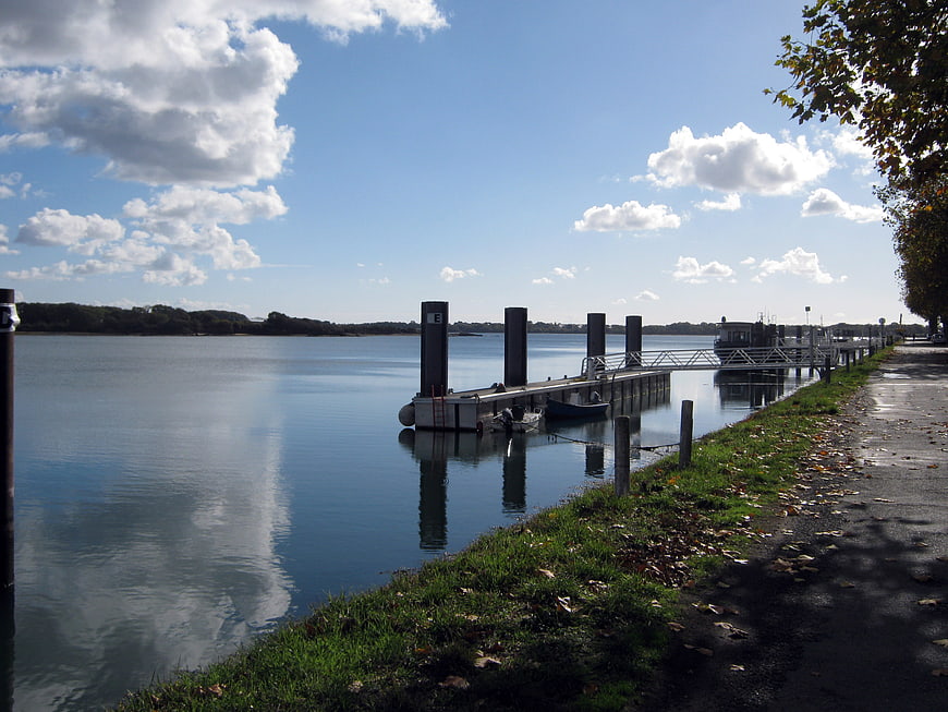 Serene River Dock with Calm Water and Blue Sky