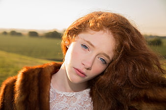 Portrait of Redhead Woman in Fur Coat Outdoors