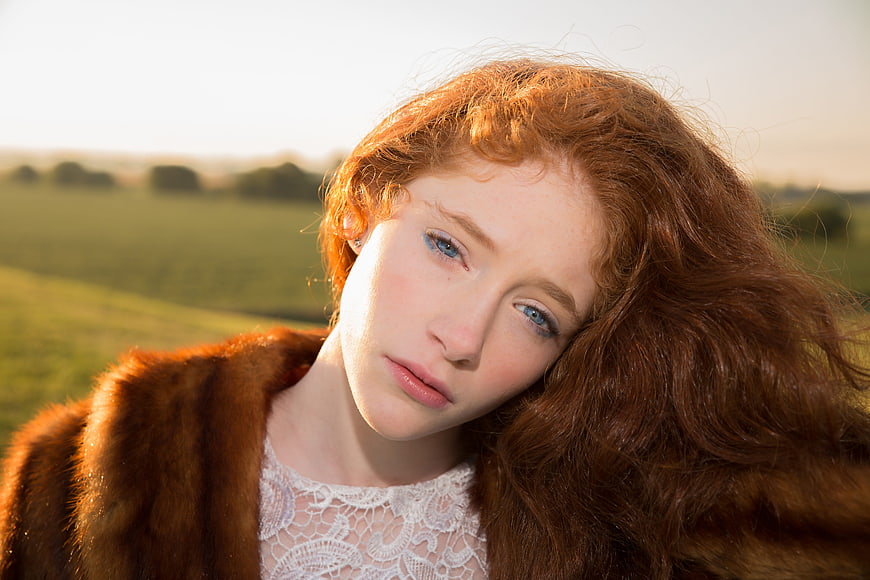 Portrait of Redhead Woman in Fur Coat Outdoors