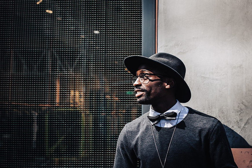 Stylish Man in Fedora and Bowtie Looking Away