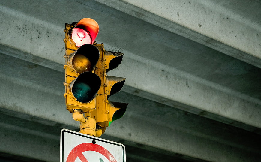 Red Traffic Light Under Concrete Overpass