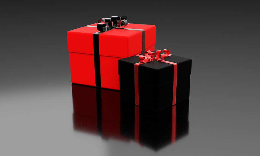 Red and Black Gift Boxes with Ribbons on Reflective Surface