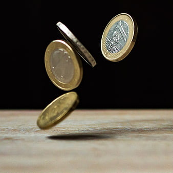 Euro Coins Falling on Wooden Surface