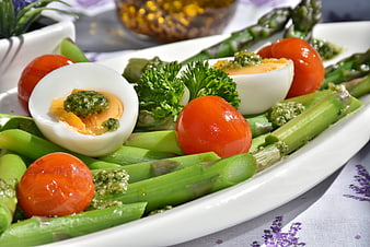 Healthy asparagus salad with hard-boiled eggs and pesto