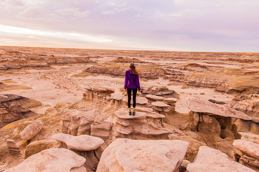 Woman Hiking in Desert Badlands Landscape