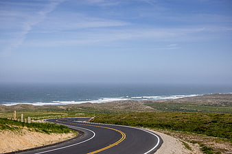 Winding coastal highway leading to the ocean horizon