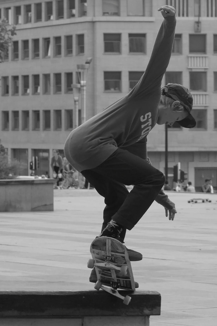 Skateboarder Grinding on Urban Bench in Black and White