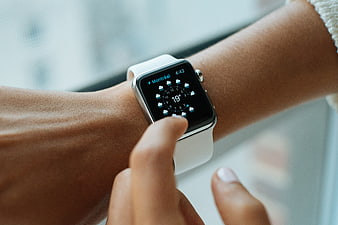 Close-up of person checking weather on smartwatch