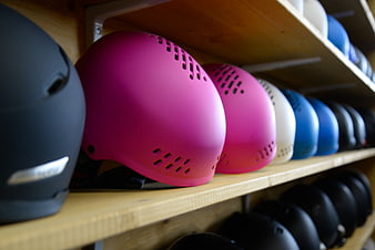 Colorful Ski Helmets on Wooden Shelf