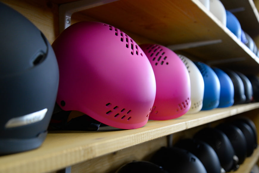 Colorful Ski Helmets on Wooden Shelf