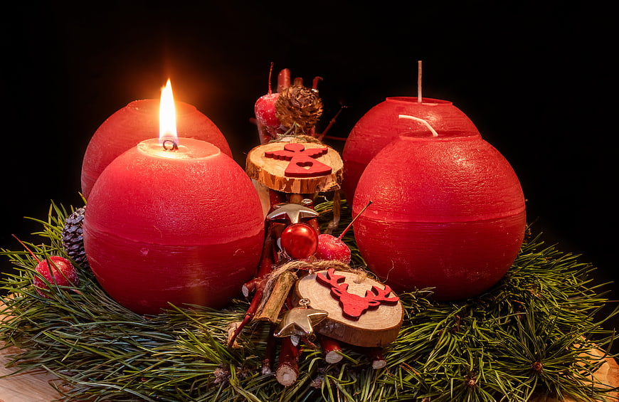 Red Advent Candles With Pine Sprigs And Wooden Christmas Ornaments