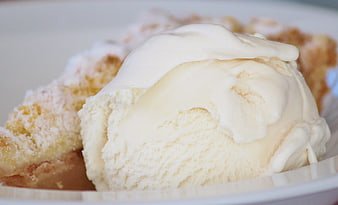 Vanilla Ice Cream Scoop With White Sauce On Cake