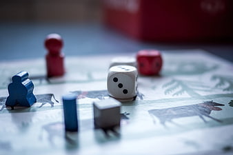 Close-up of wooden game pieces and dice on a board