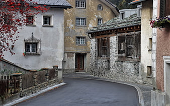 Historic European Village Street With Traditional Stone And Plaster Buildings