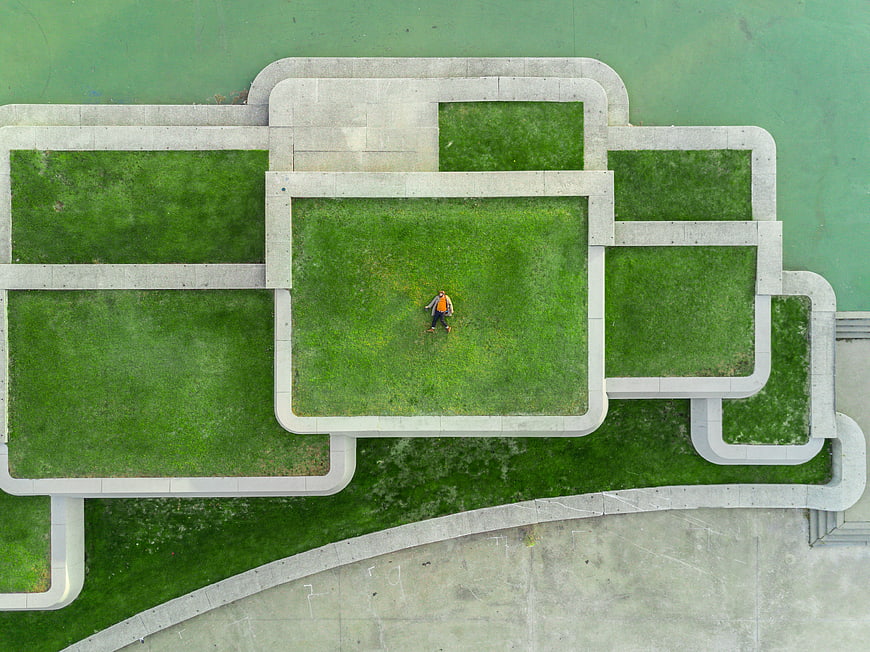 Aerial view of person standing on geometric green roof