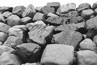 Black and white close-up of large coastal rocks and boulders