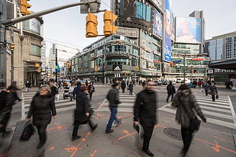 Busy City Intersection with Pedestrians and Billboards
