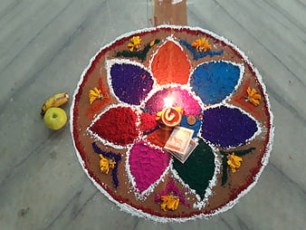 Colorful Rangoli Art with Diya and Offerings on Floor