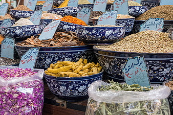 Traditional Iranian spice market with colorful herbs and turmeric