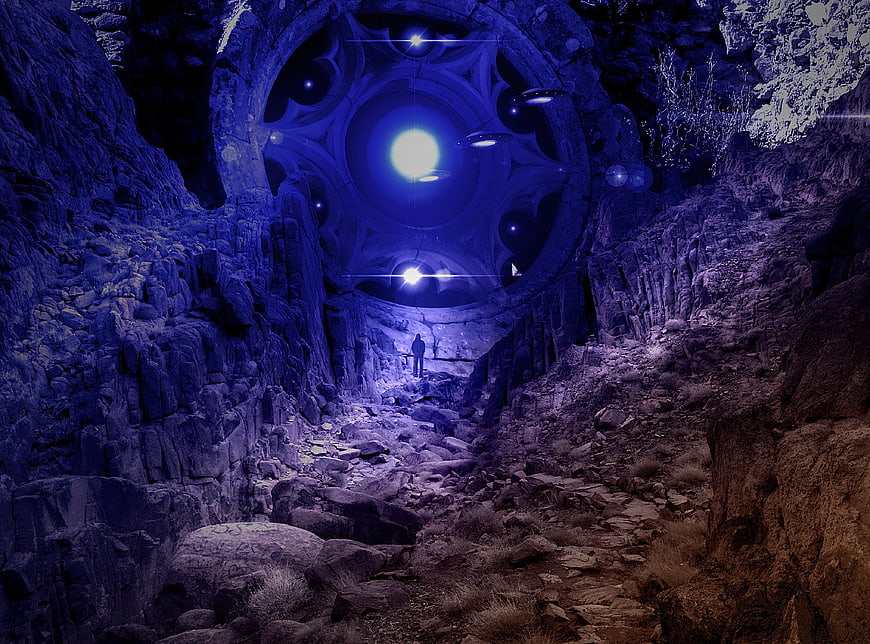 Futuristic UFO hovering in a dark rocky canyon with a lone figure