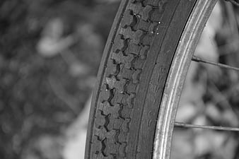 Close-up of cracked bicycle tire tread in black and white