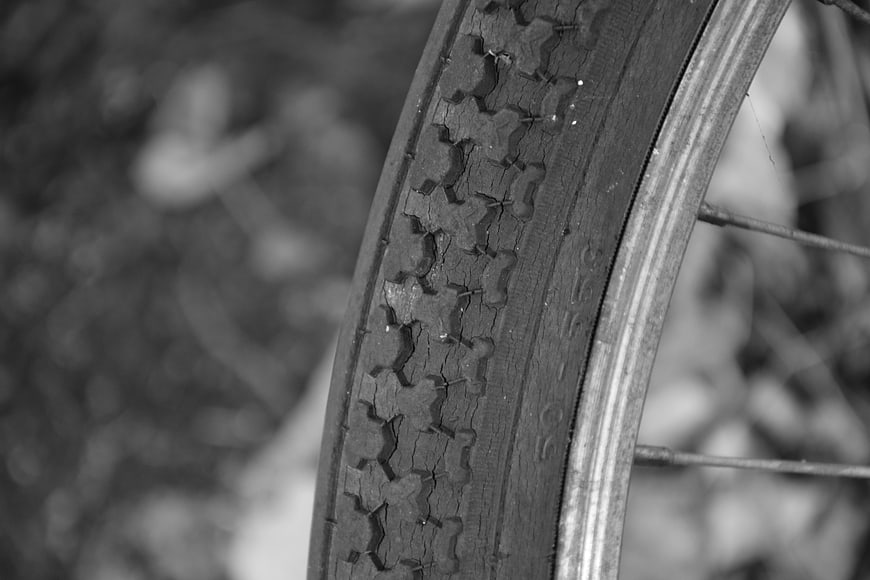 Close-up of cracked bicycle tire tread in black and white