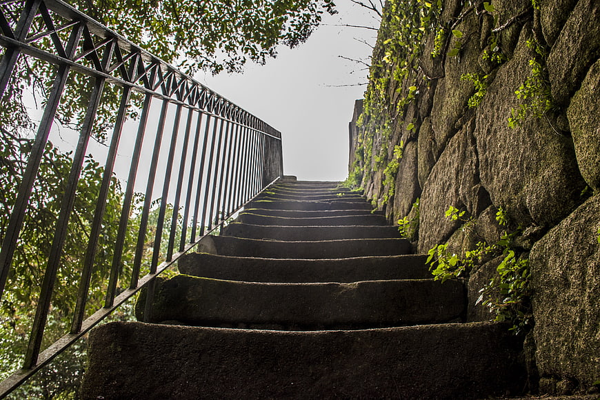 Low angle view of stone stairs leading up a rocky path