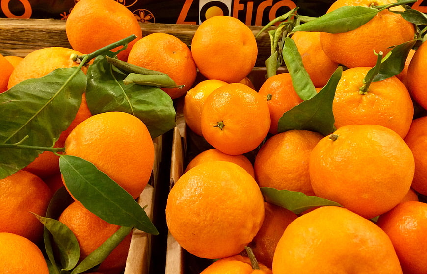 Fresh Oranges with Green Leaves in Wooden Crates