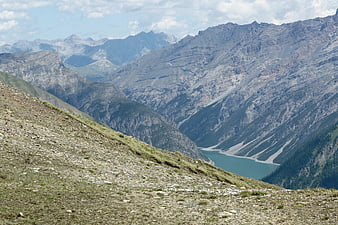 Panoramic Alpine Landscape with Turquoise Lake and Rocky Slopes