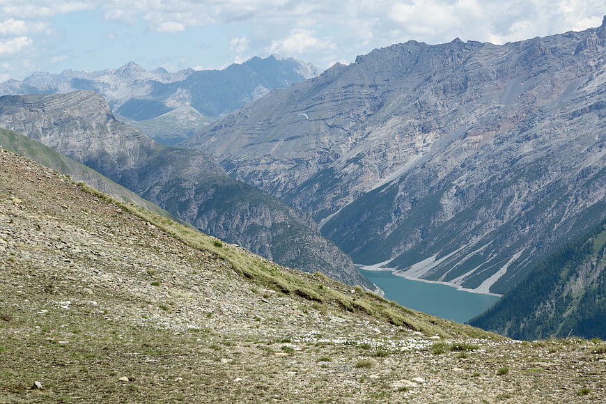 Panoramic Alpine Landscape with Turquoise Lake and Rocky Slopes
