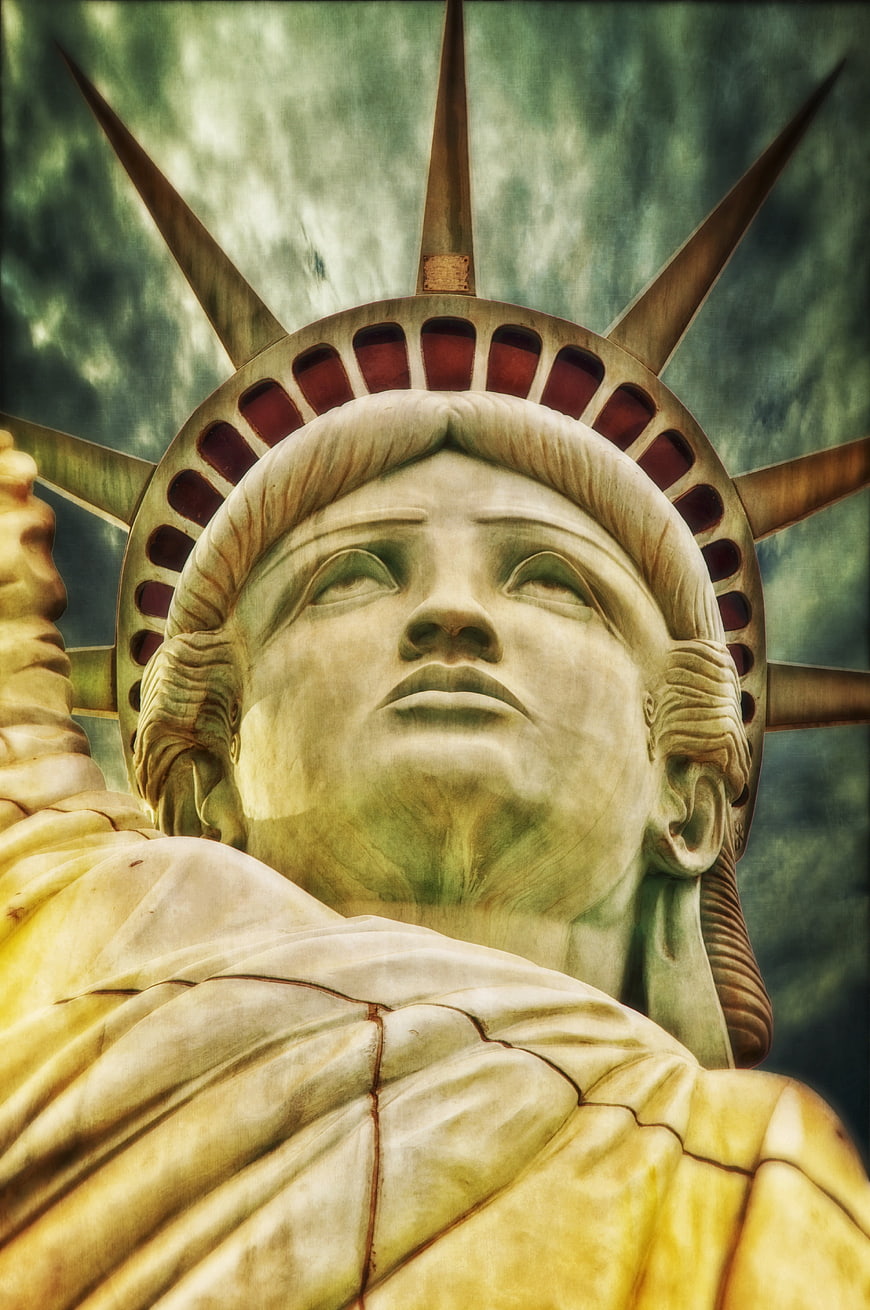 Close-up of Statue of Liberty Head with Dramatic Sky