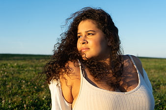 Portrait of Woman with Curly Hair in Golden Hour Sunlight