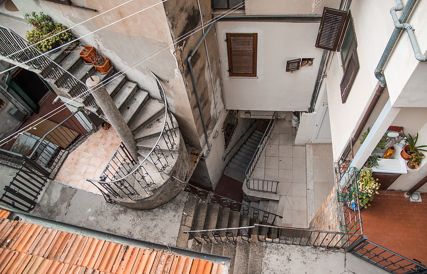 Bird's eye view of spiral staircase in Italian courtyard