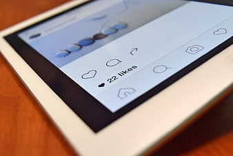 Close-up of social media likes on white tablet screen