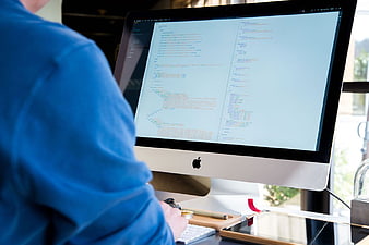 Programmer Coding on Mac Computer Screen