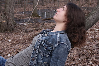 Young woman relaxing in autumn forest