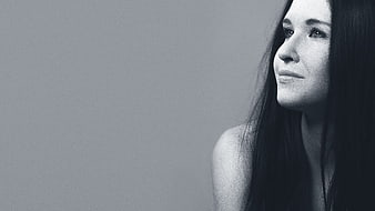 Black and white portrait of a smiling woman with long hair