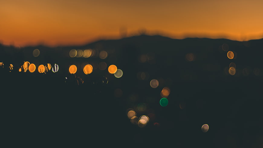 Abstract Bokeh Lights at Sunset with Orange Sky