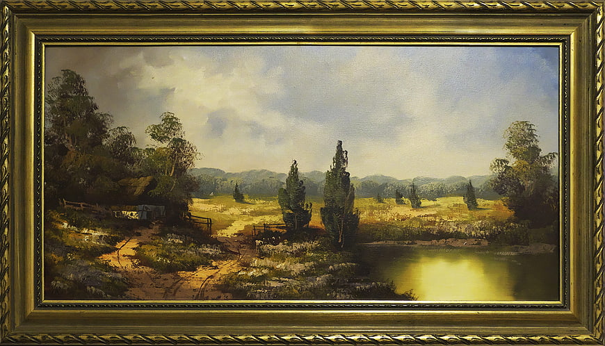 Framed vintage landscape painting of a pastoral countryside scene