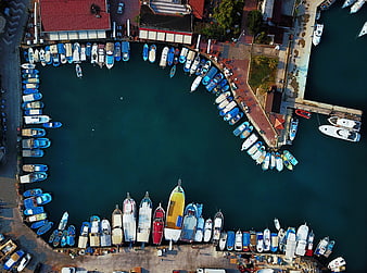 Aerial View of Colorful Boats in a Circular Harbor