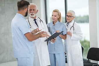 Medical team discussing patient records in hospital