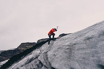 Mountain Climber Ascending Glacier Slope with Ice Axe