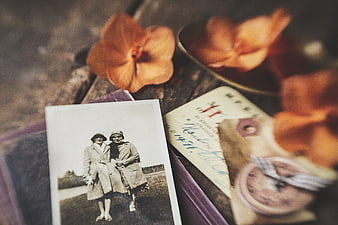 Vintage black and white photo of two women with orange flowers