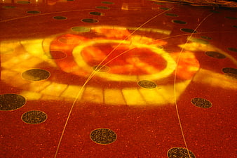 Abstract red floor with circular pattern and light reflection
