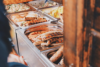 Grilled sausages and buffet food at a catering event