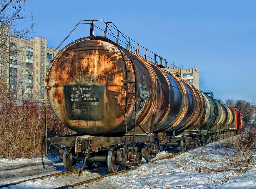 Rusty Tank Cars On Snowy Railway Tracks In Winter