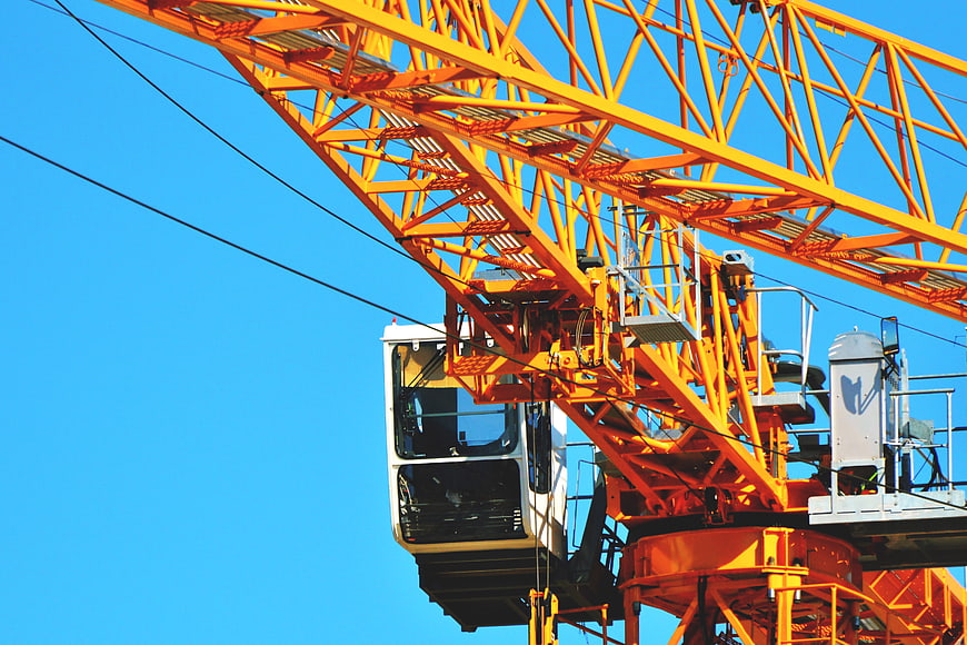 Yellow Construction Crane Against Blue Sky
