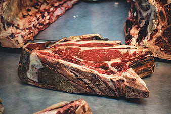 Raw dry-aged beef steak close-up on metal surface